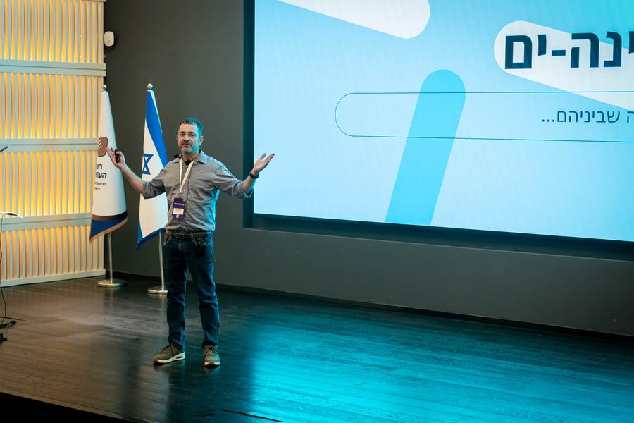 Amit Perry on stage opening the hackathon